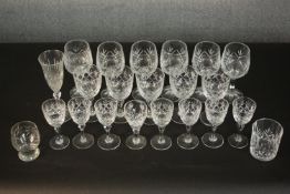 A collection of twenty one pressed glass and crystal drinking glasses, including a set of six wine