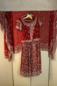 A very heavy red embroidered and beaded Indian bridal outfit, including sari and dress. (size for