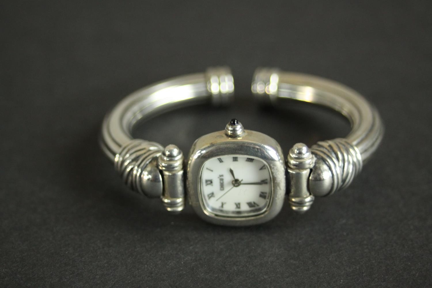 A collection of silver bangles, a silver bangle watch and a tortoiseshell and silver articulated - Image 5 of 9
