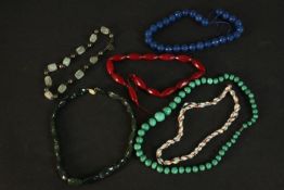 A collection of necklaces and knotted beads including a graduated malachite bead necklace, a