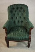 A William IV mahogany armchair, upholstered in green fabric with a buttoned back, with carved