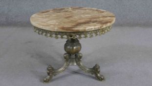 A circa 1970's circular coffee table, with an onyx top on a brass base, the bulbous stem issuing