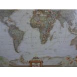 A large framed and glazed National Geographic coloured map of the world. H.90 W.125cm.