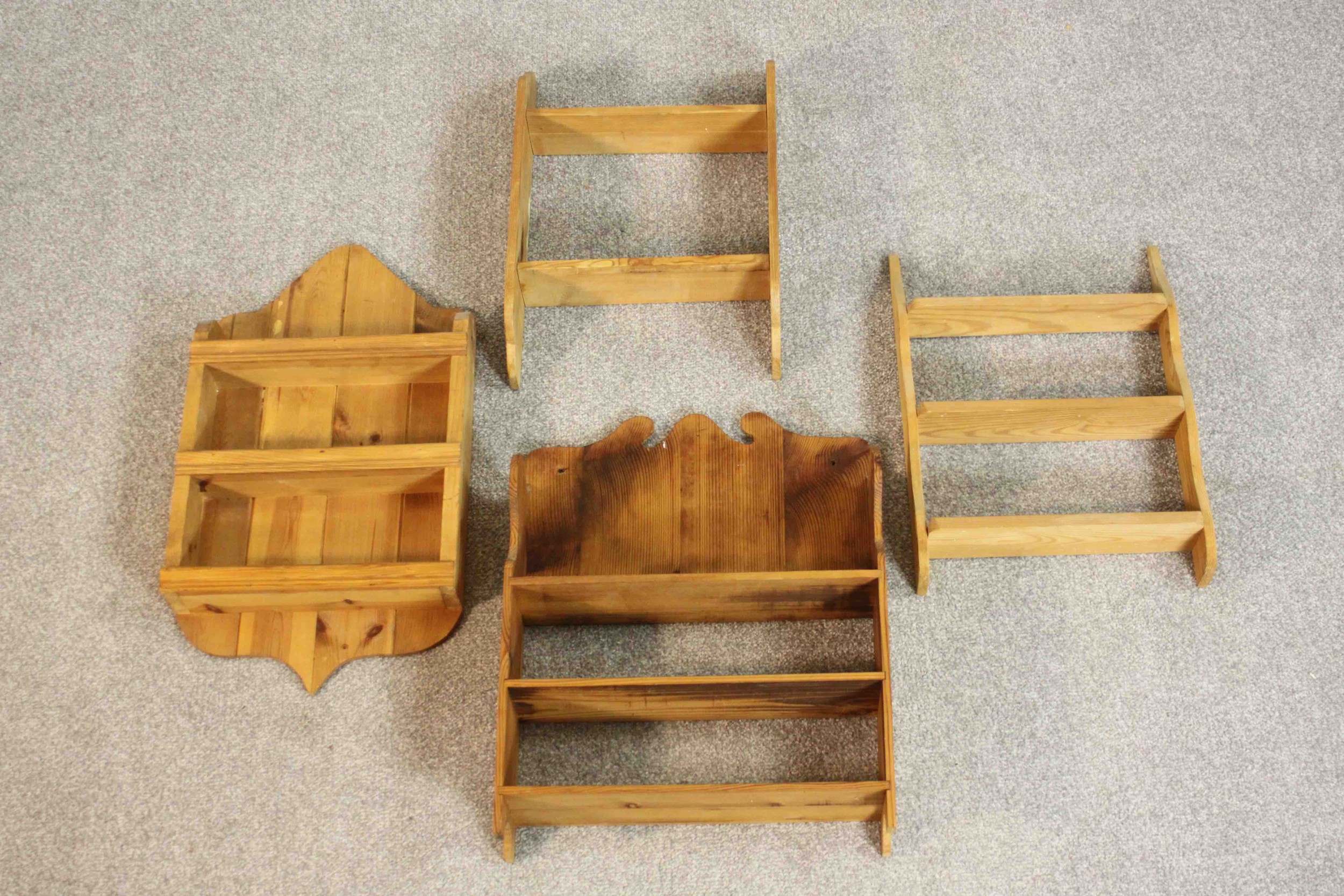 Four pine wall mounted shelving units, one with a closed back. H.64 W.34 D.10cm.