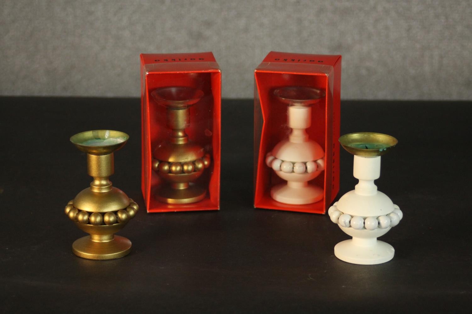 Two sets of Aarikka Finnish golden and white carved candlesticks with beaded detailing. One of