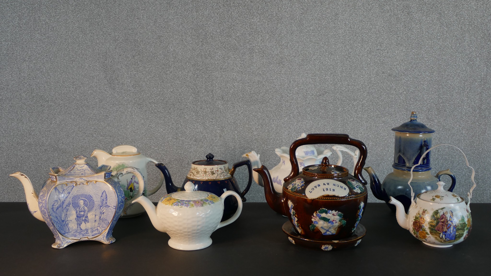 A collection of eight 19th and 20th century tea pots, including a barge ware ceramic tea pot and