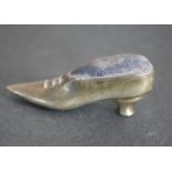 A silver pin cushion in the form of a heeled shoe. H.2cm. 22g