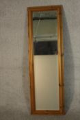 A contemporary pine framed long mirror, with a rectangular bevelled plate. H.134 W.43cm.