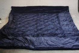 A very large dark blue velour Laura Ashley quilted bed throw. L.250 W.220cm.