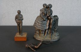 A bronze figure of a man smoking a pipe along with a spelter figure of a female swimmer (arm broken)