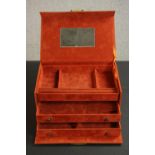 A burnt orange suede effect travelling jewellery case, with two sliding drawers and a sectioned