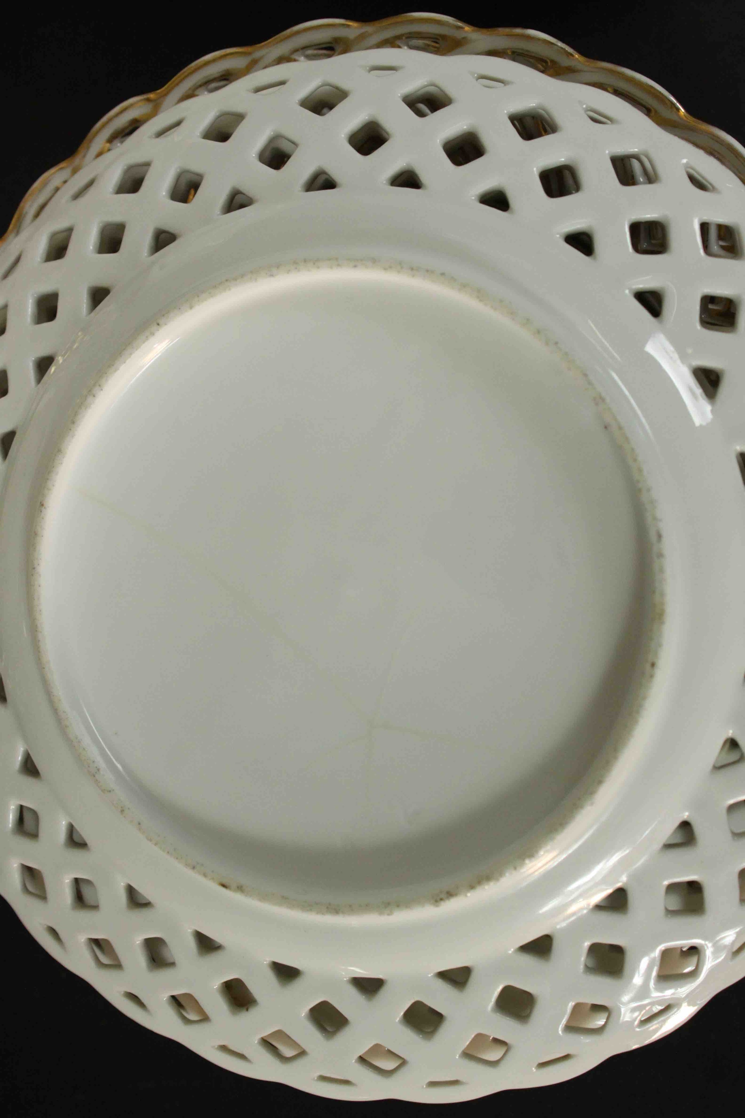 A set of eleven 19th century hand painted porcelain plates with pierced gilded lattice work rims and - Image 6 of 6