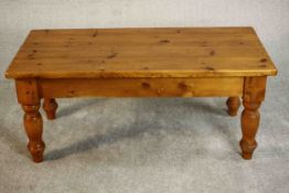A late 20th century pine coffee table, the rectangular top on turned legs. H.52 W.72 D.40cm.