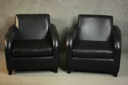 A pair of contemporary black leather armchairs, on tapering block feet.