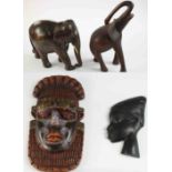 A collection of carved Tribal items, including a Kuba West African bead and brass embellished tribal