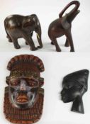 A collection of carved Tribal items, including a Kuba West African bead and brass embellished tribal