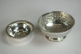 Two silver bowls, one with repousse scrolling design and beaded rim and one with a gadrooned edge.