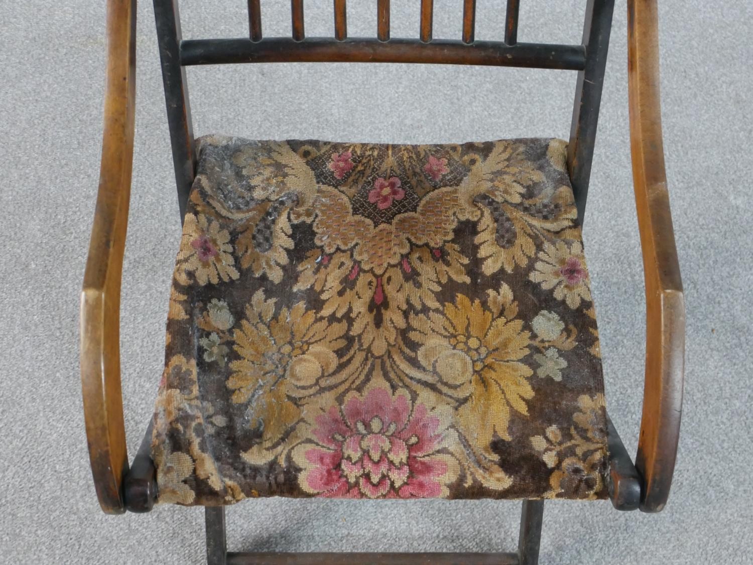 An early 20th century fruitwood folding armchair, with a spindle back, the seat upholstered in a - Image 4 of 6