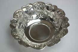 A Indian repousse floral design bowl with scalloped edge. H.5 Dia.19.5cm. Weight 175gm.