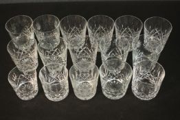A collection of sixteen cut crystal and glass tumblers with stylised foliate design. Three different