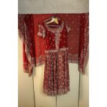A very heavy red embroidered and beaded Indian bridal outfit, including sari and dress. (sized for a