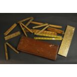 A collection of early 20th century treen boxwood and brass hinged rulers and measuring