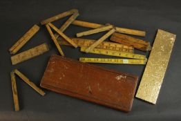 A collection of early 20th century treen boxwood and brass hinged rulers and measuring