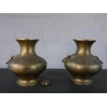 A pair of 20th century engraved twin handled Oriental brass vases. (handle loose) H.22.5 W.20cm