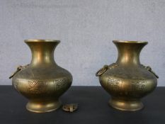 A pair of 20th century engraved twin handled Oriental brass vases. (handle loose) H.22.5 W.20cm