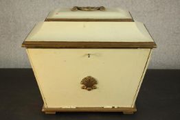 A 19th century sarcophagus form box, painted an ivory hue and parcel gilt, with a handle to the