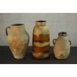 Two Mediterranean terracotta oil jars and a West German brown glaze vase. H.40 Dia.16cm. (largest)