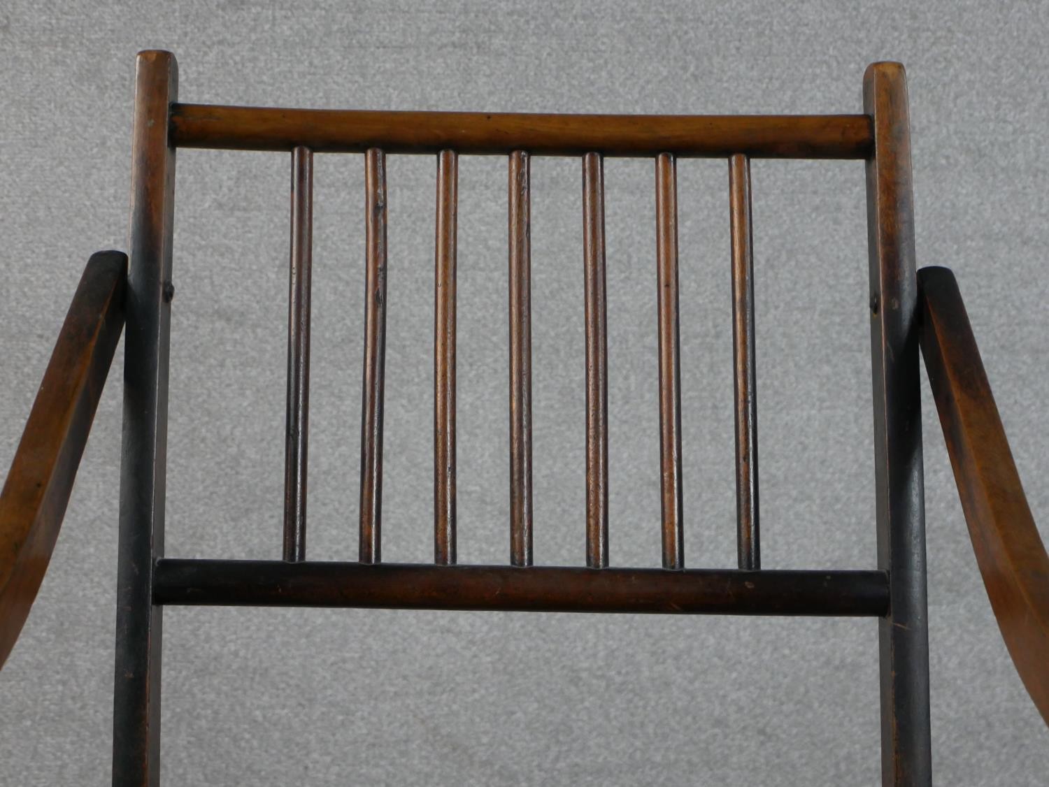An early 20th century fruitwood folding armchair, with a spindle back, the seat upholstered in a - Image 5 of 6