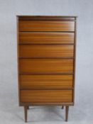 A circa 1970s teak tallboy chest of six graduated drawers, on tapering cylindrical legs. H.124 W.