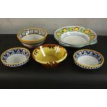 A collection of five hand painted Continental majolica ceramic glazed bowls, some painted with fruit