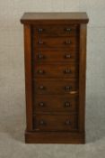 A Victorian oak Wellington chest of seven graduated drawers on a plinth base. H.103 W.50 D.30cm.