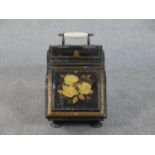 An early 20th century painted floral design toleware coal scuttle with ceramic handle. H.40 W.28 D.