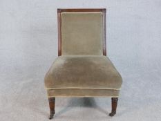 A Regency mahogany nursing chair, the square back with roundels to the corners, upholstered in brown