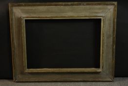 A white painted carved picture frame. H.55 W.71cm.