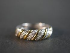 A 9 carat white and yellow gold diamond set band, set with six round eight cut diamonds with a