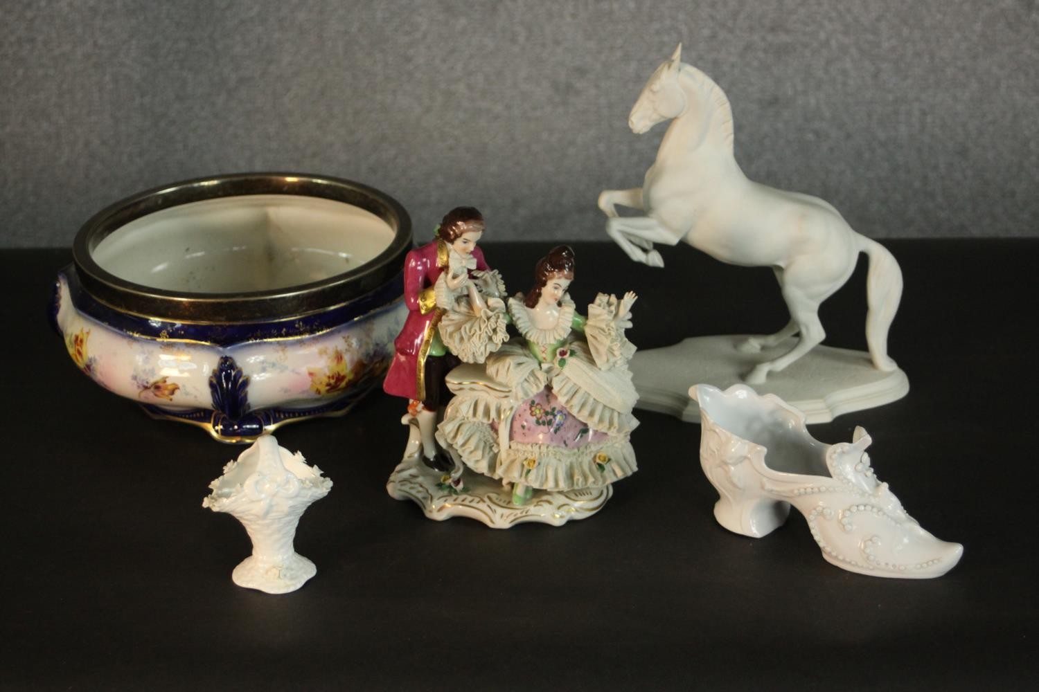 A collection of ceramics and porcelain, including a bisque porcelain rearing horse, a basket
