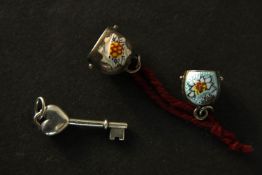 A Tiffany & Co charm along with two vintage sterling silver Swiss cowbell charms.