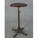 A late Victorian adjustable occasional or lamp table, the circular dished top on a telescopic