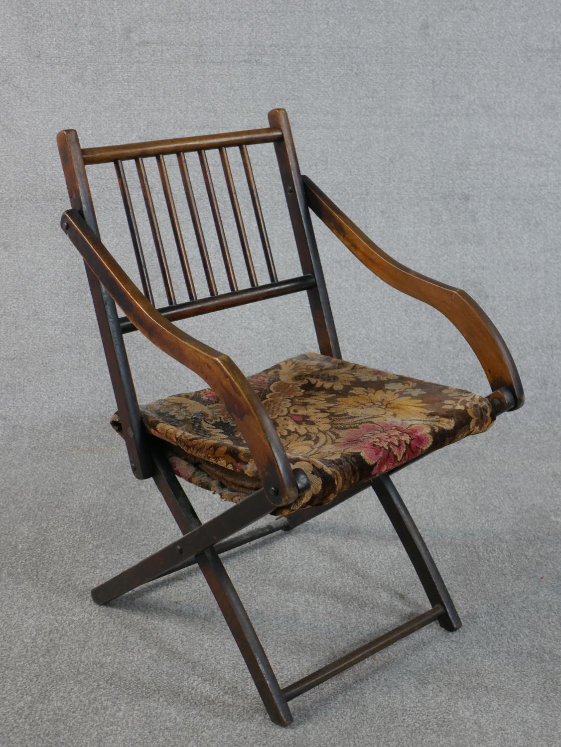 An early 20th century fruitwood folding armchair, with a spindle back, the seat upholstered in a - Image 2 of 6