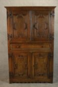 A 17th century oak cupboard, probably Dutch, of two pairs of geometrically panelled doors divided by