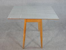 A mid century vintage drop flap kitchen table with gingham check laminated top. H.74 W.89 D.67.