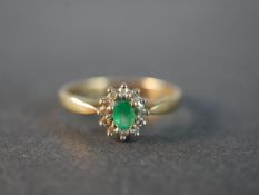 A 9 carat gold vintage emerald and diamond cluster ring, set to the centre with an oval mixed cut