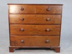 A 19th century mahogany chest of two short over three long graduated drawers with turned knob