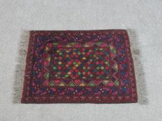 An Afghan rug with all over geometric design. L.69 W.53cm
