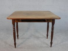 A 19th century walnut Pembroke table, with two drop leaves over an end drawer and a dummy drawer