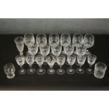 A collection of twenty one pressed glass and crystal drinking glasses, including a set of six wine